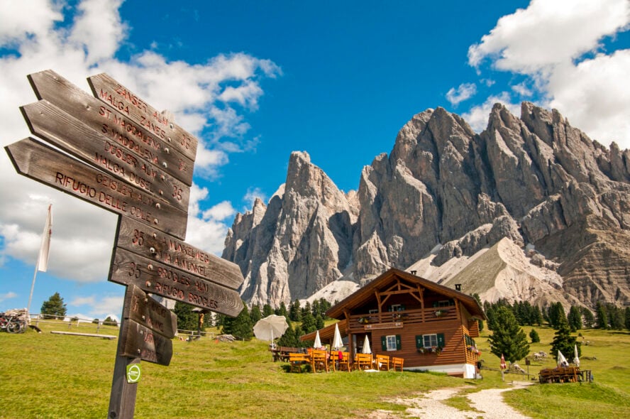 Trailhead placed in front of a mountain hut in the Dolomites