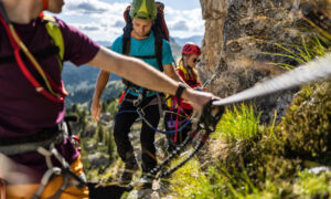 Group of people climbing a via ferrata in the Dolomites