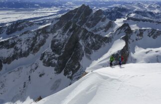 Two skiers getting ready to drop in atop Grand Teton. Photo courtesy of The Mountain Guides