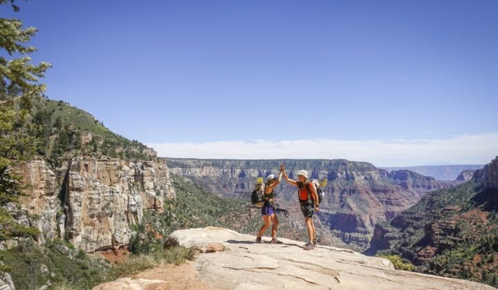 Hikers celebrating a successful climb in the Grand Canyon.
