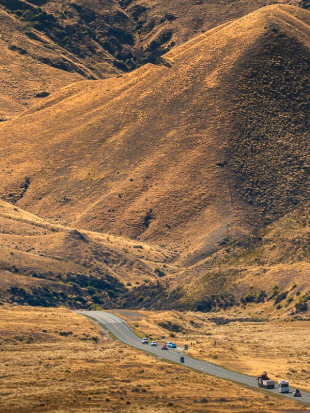 Hiker on a peak of a mountain in New Zealand