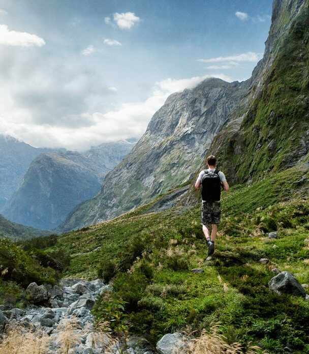 Hiker on a peak of a mountain in New Zealand
