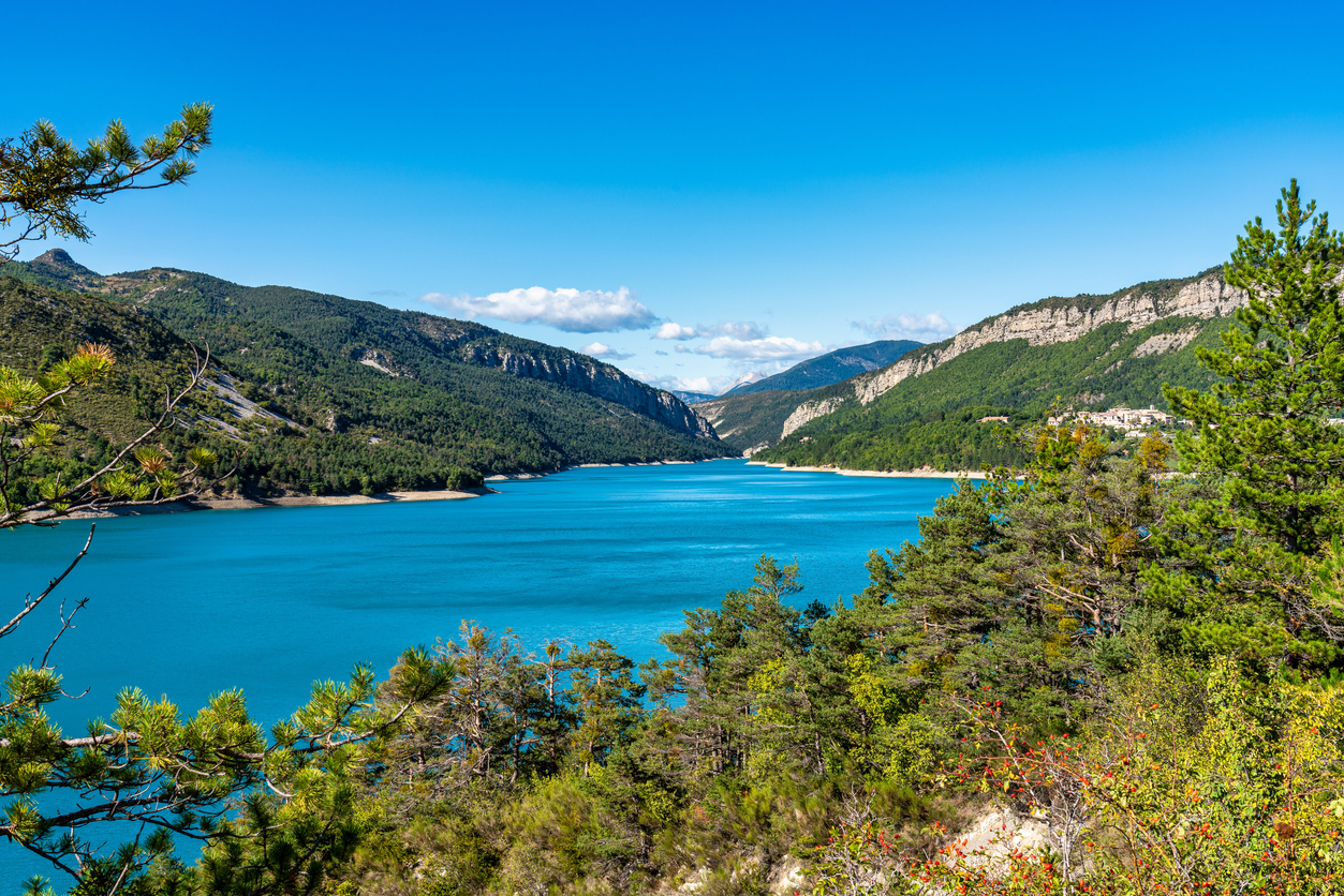 Turquoise lake Castillon surrounded by woods near the Verdon Gorge river canyon.