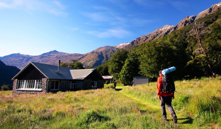 A hiker heading towards the Aspiring Hut in New Zealand