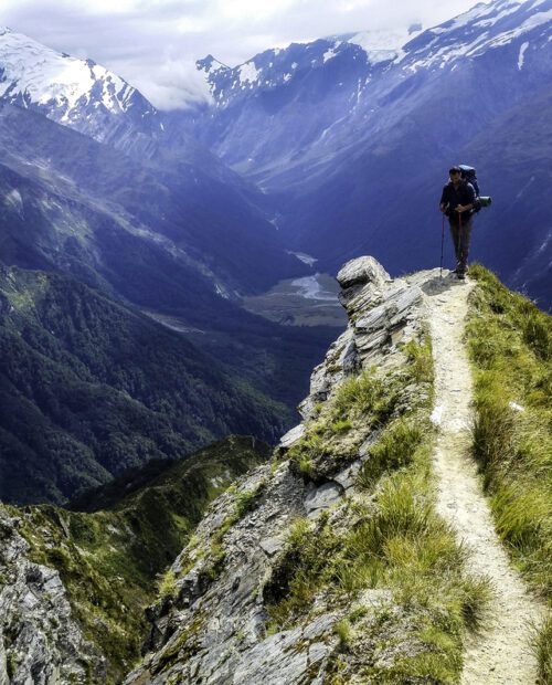 Hiker on a peak of a mountain in New Zealand