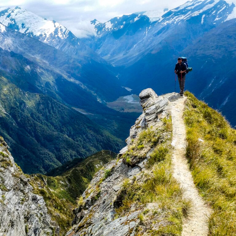 Hiker on a peak of a mountain in New Zealand