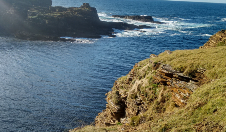 Cliffs along the sea in the Orkney Islands, United Kingdom.