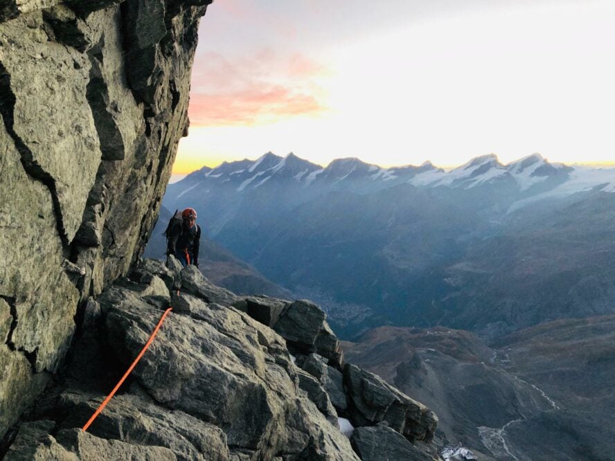 A climber coming upon a ledge high up on Matterhorn in Switzerland. 