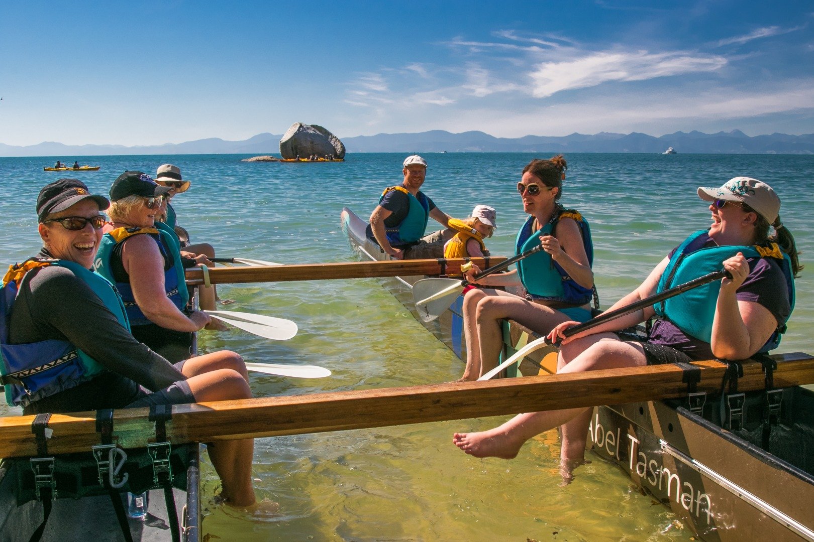 Travelers in a traditional Maori Waka in New Zealand.