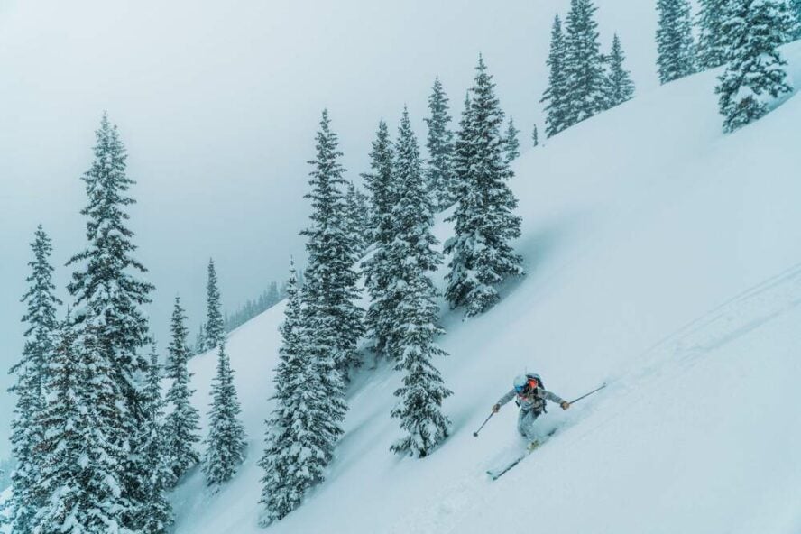 A skier carving fresh lines in the San Juan Mountain backcountry.