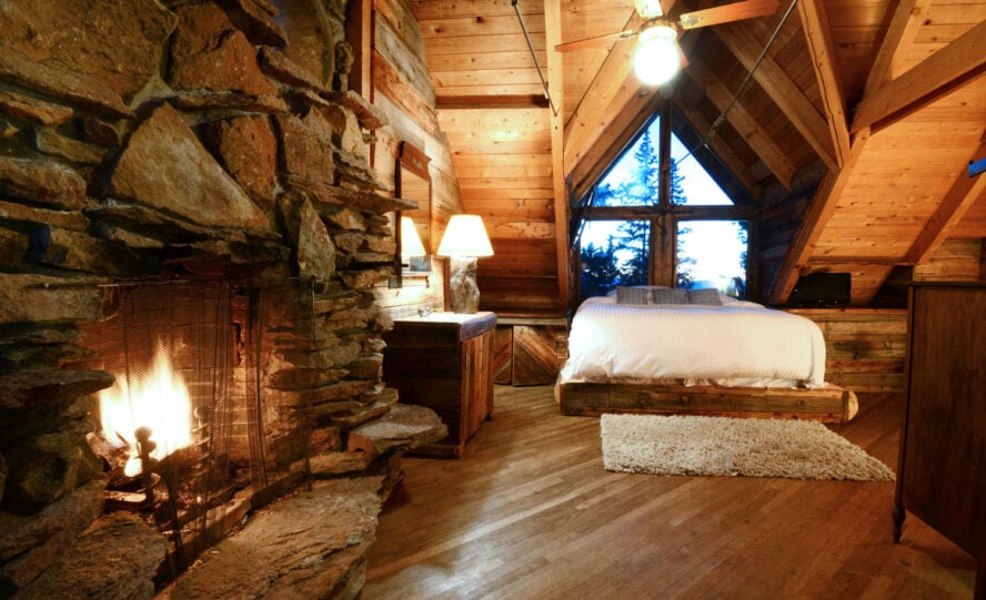 Luxury bedroom complete with a roaring fireplace at The Observatory at Alta Lakes.