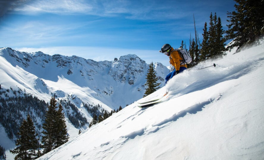 A skier riding down fresh backcountry snow on Silverton Mountain in Colorado.