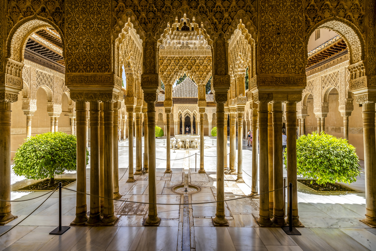 Courtyard with ornate arches in the Alhambra Palace, Granada.
