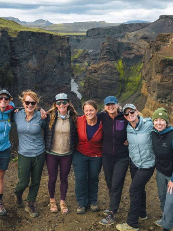 Hikers traversing the river crossing in Iceland.
