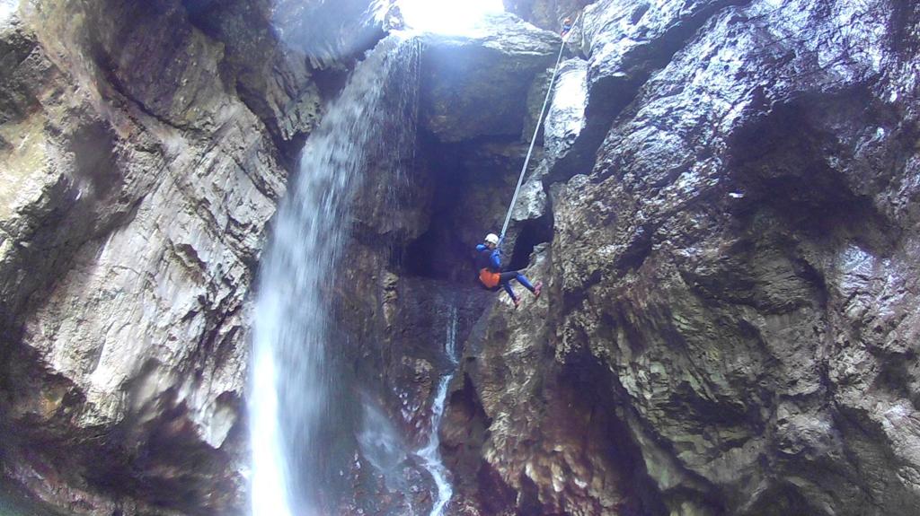 One canyoneer rappelling down the waterfall