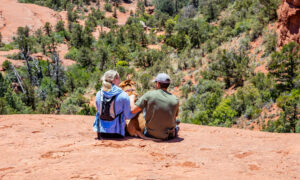 Pair of hikers sitting on a ledge in Sedona