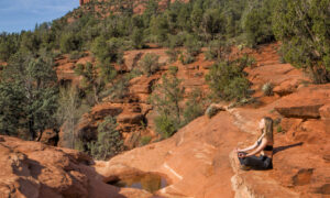 Woman meditating near the Seven Sacred Pool in Sedona