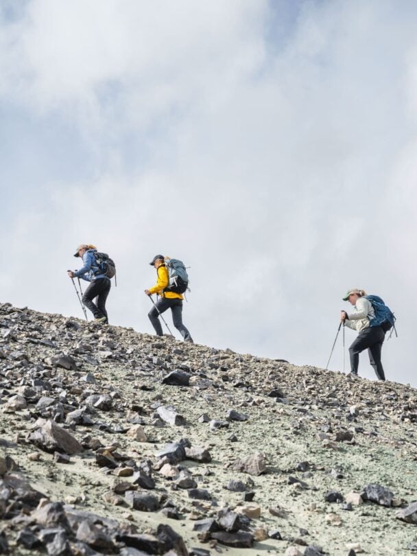 Hikers traversing the river crossing in Iceland.