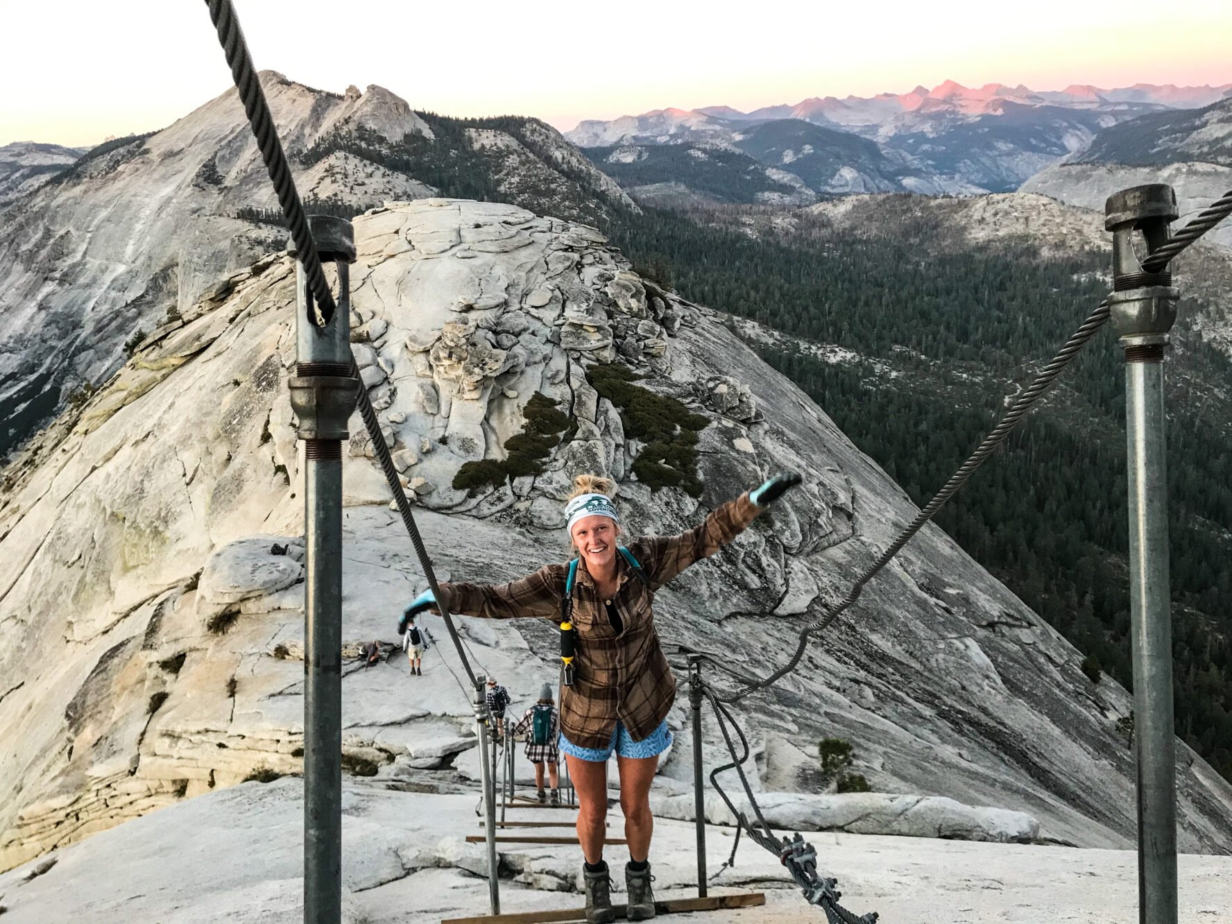 A hiker climbing with cables