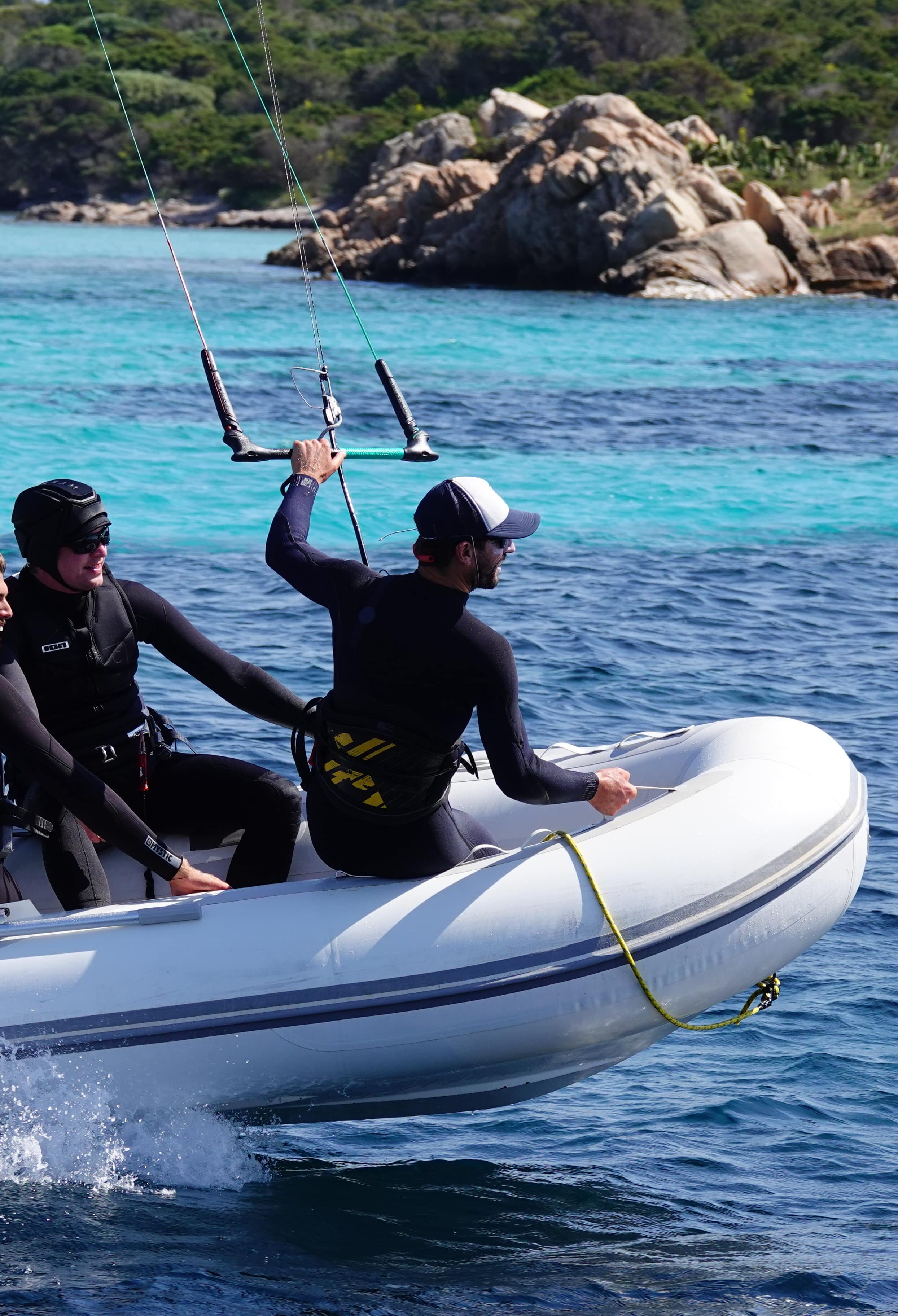 Group of kitesurfers in a dingy catching the wind