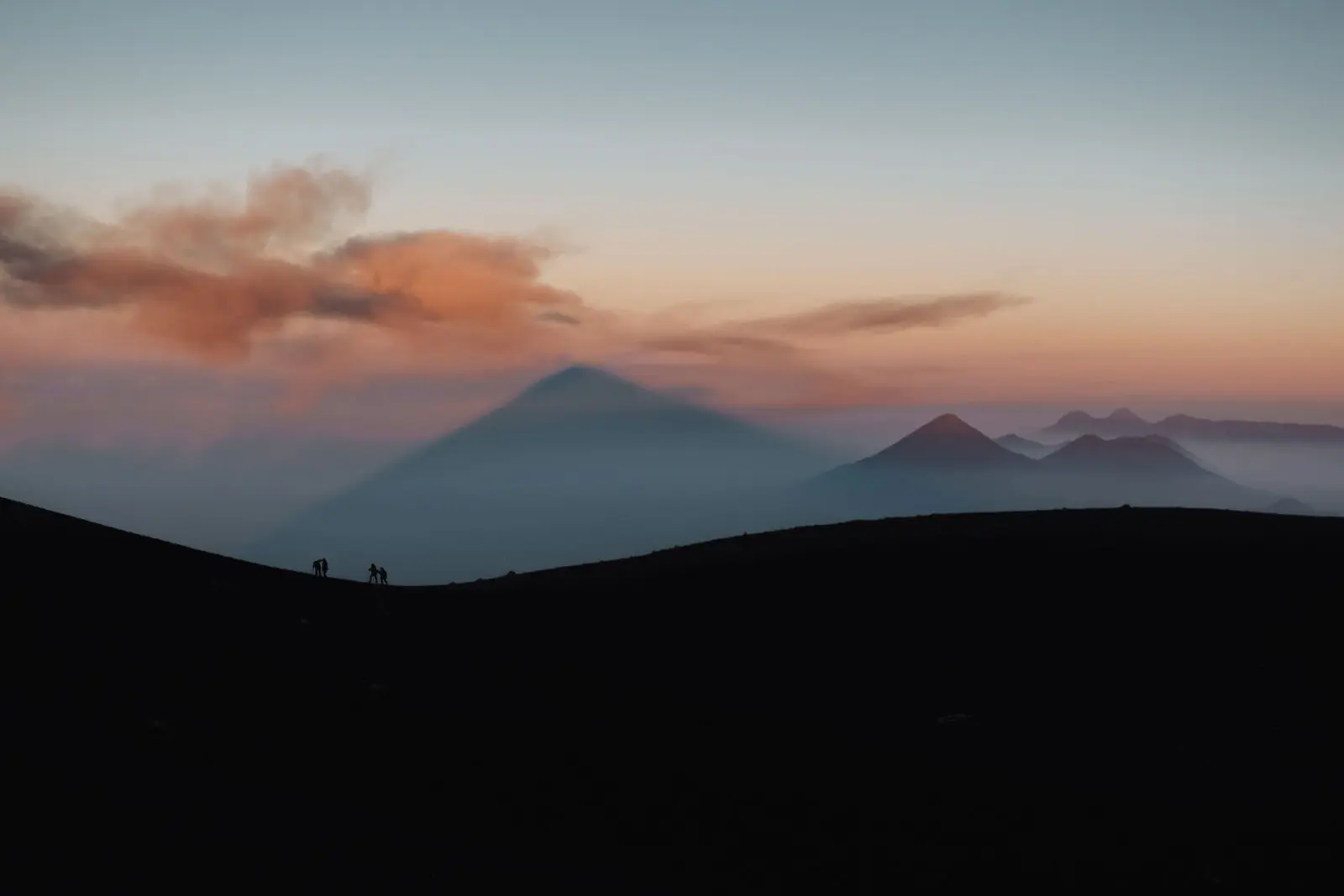 Silhouettes of hikers on the way to Acatenango summit
