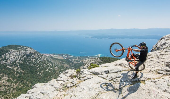 A mountain biker celebrates his summit of Vidova Gora on the island of Brač.