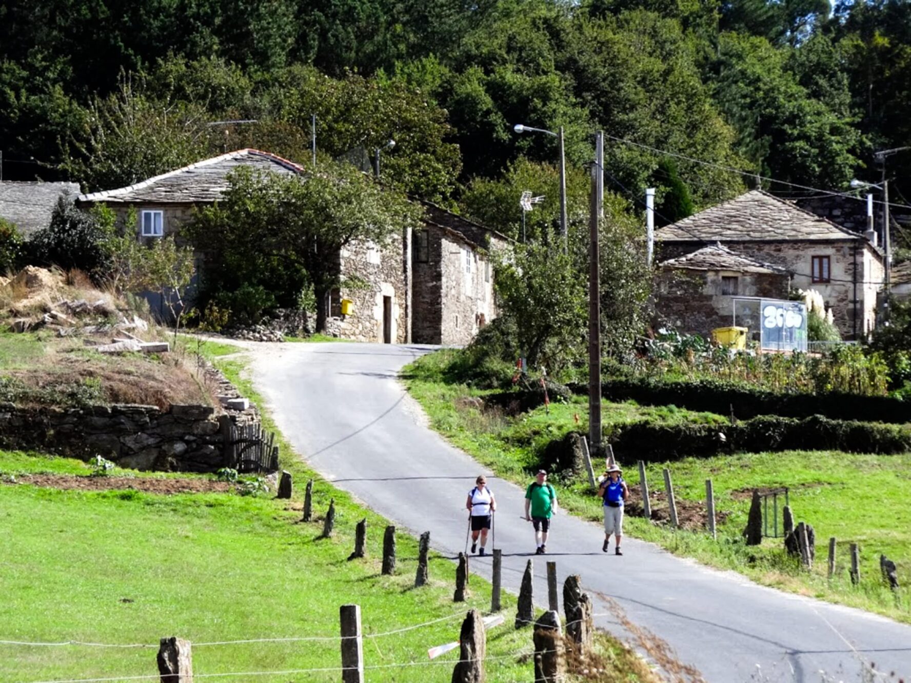 Camino hikers walking through a village