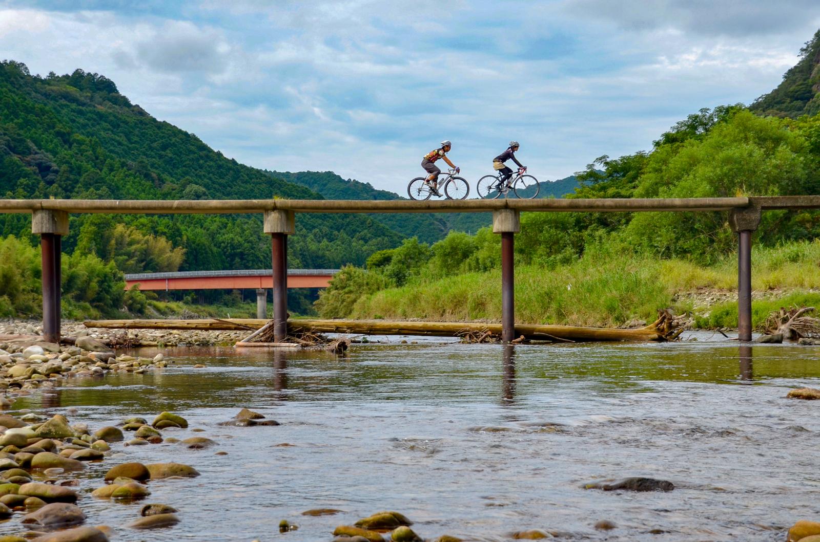 Cyclists going over bridge