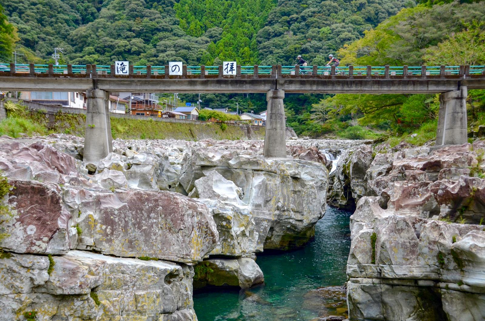 Cyclists going over bridge in Japan