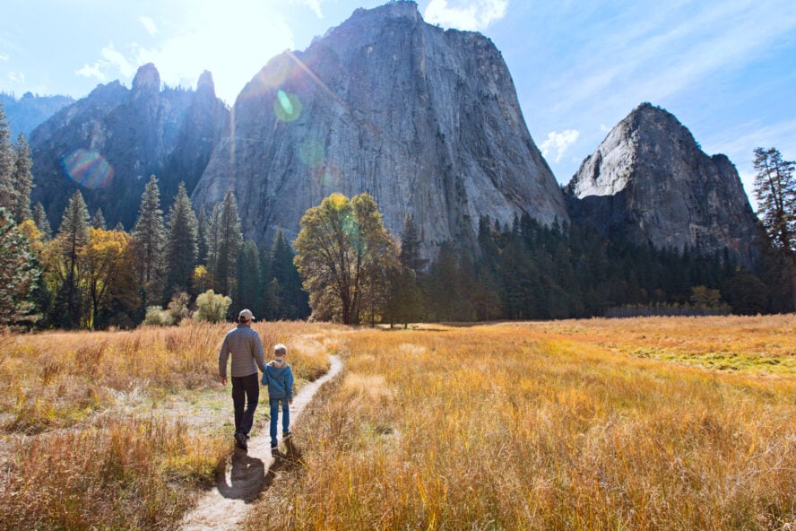 Father and son hiking through Yosemite National Park.