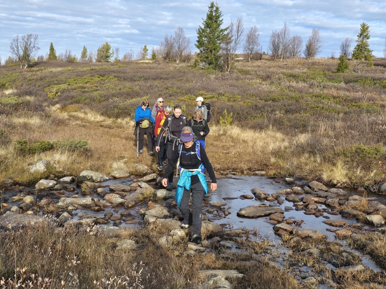 Fording river in Norway, women