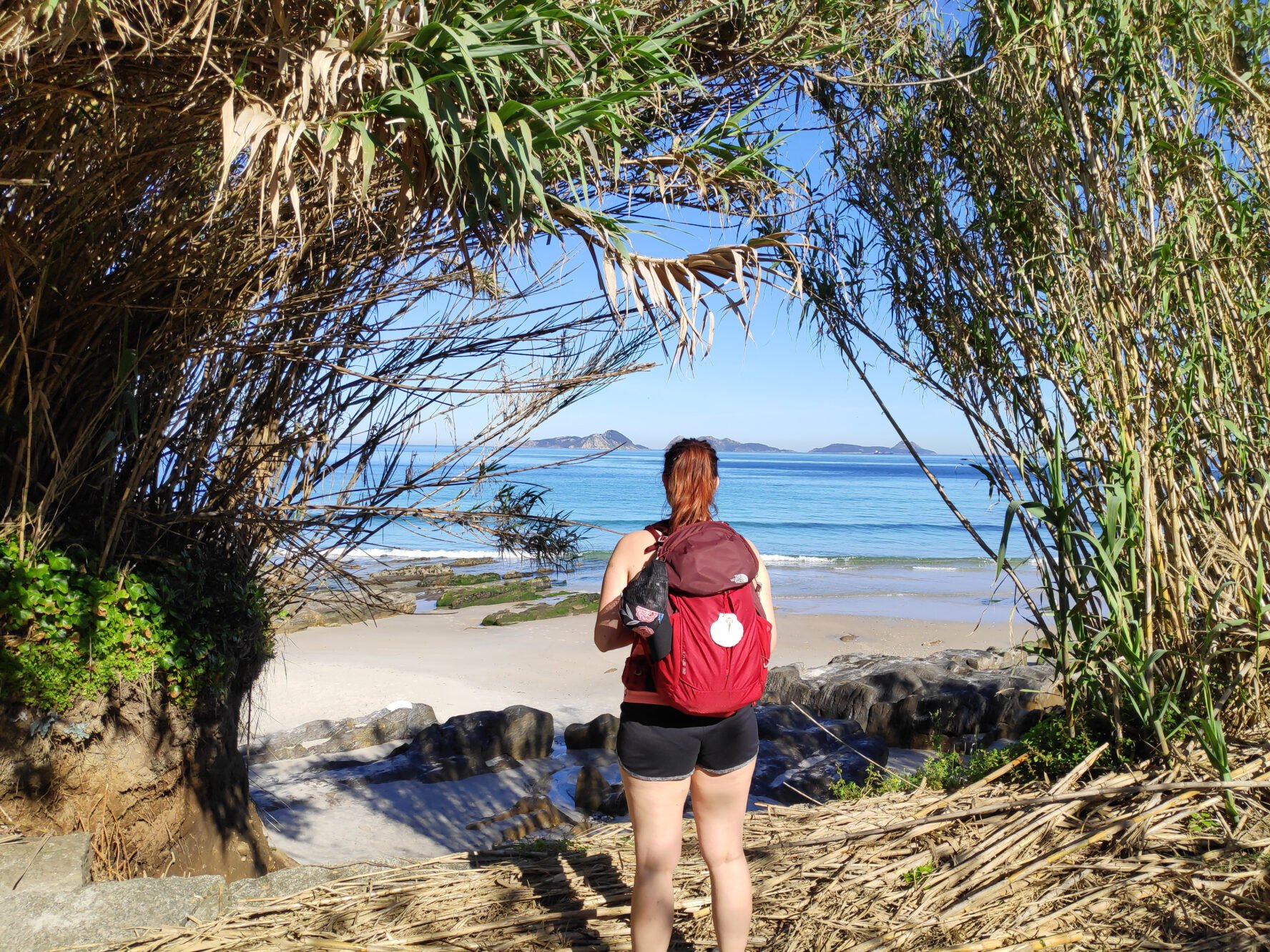 One hiker on a beach in Spain