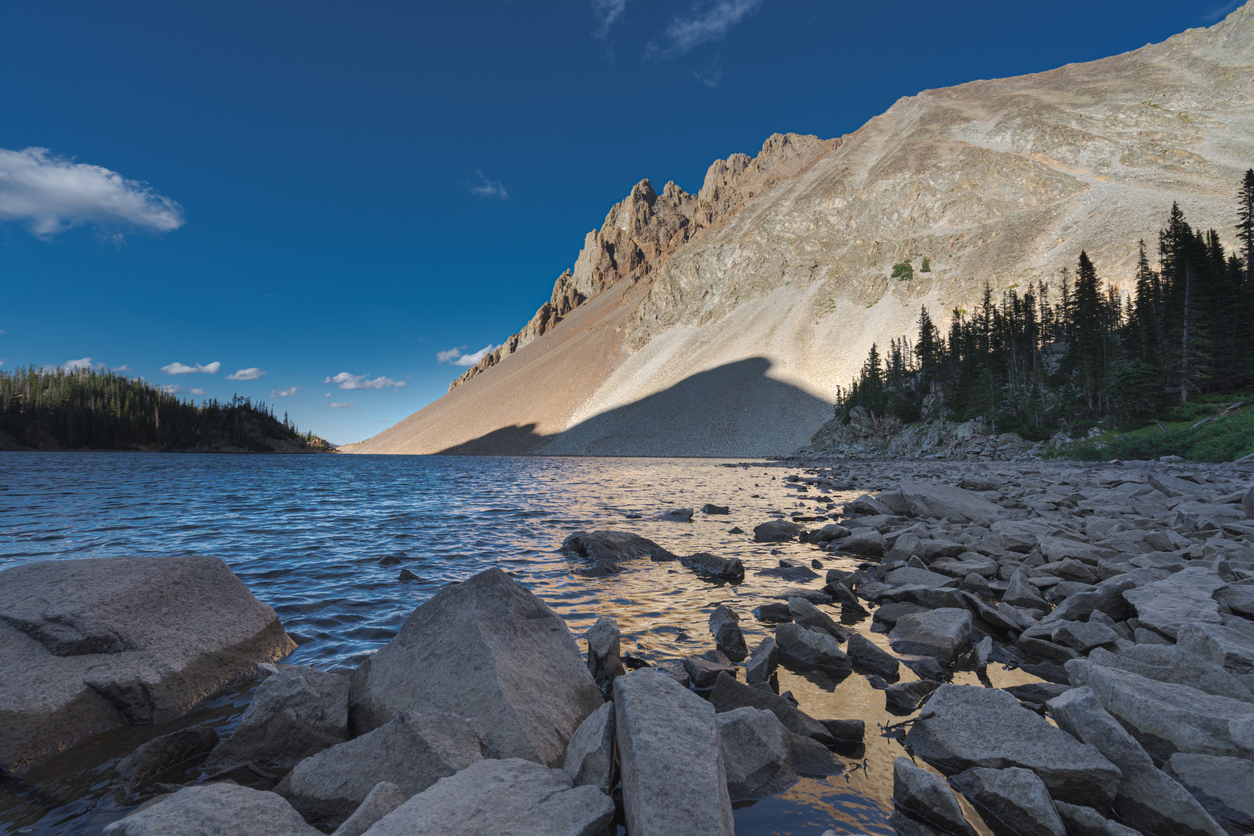 Crystal-clear alpine lake in Colorado’s State Forest State Park encircled by rugged mountains.