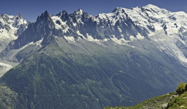 A series of snow-capped peaks forming a mountain range seen along the Tour du Mont Blanc.