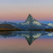 A reflection of the Matterhorn into Lake Stellisee during sunrise.