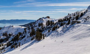 Skiers going downhill above Lake Tahoe