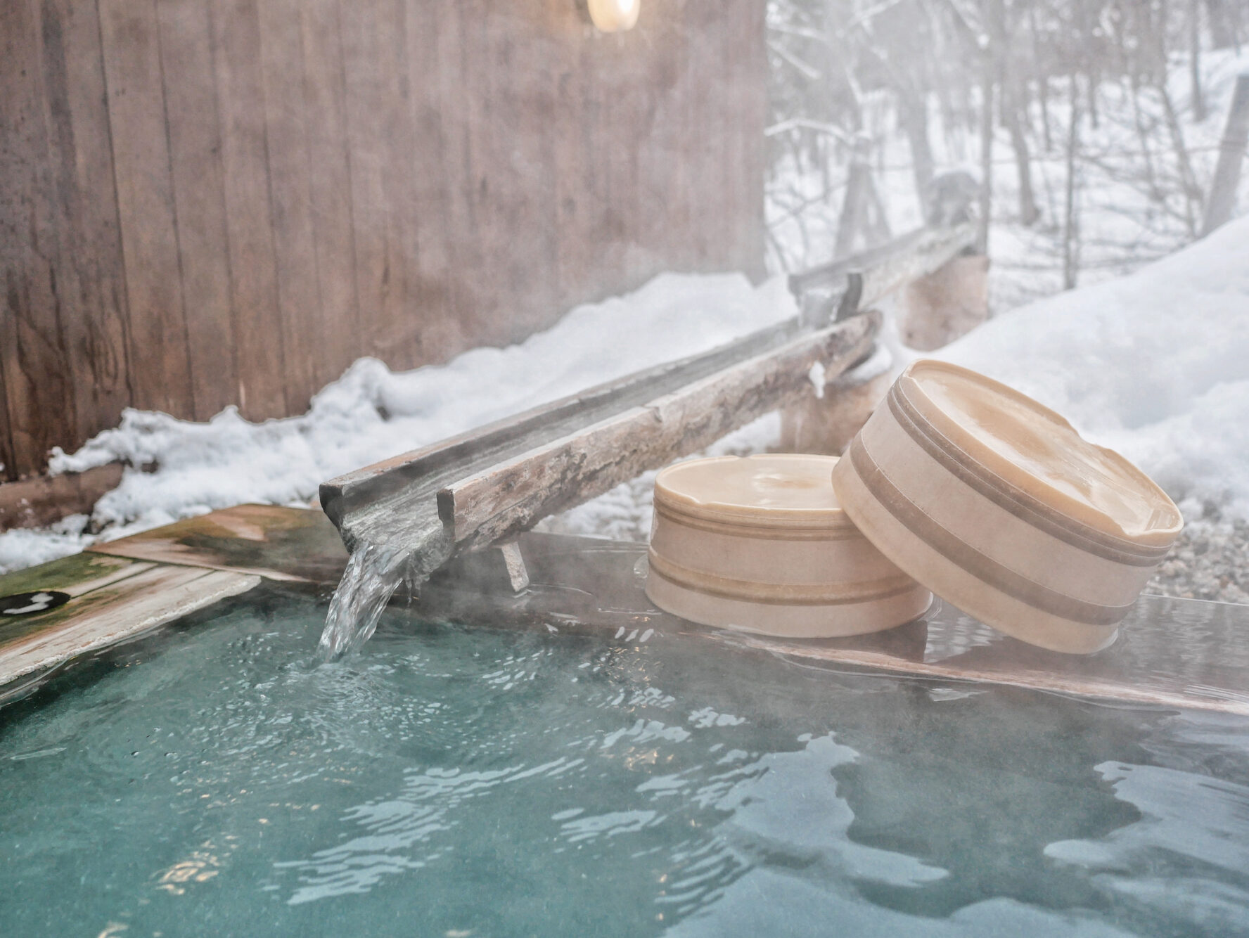 Water flowing into a natural hot spring during the winter.
