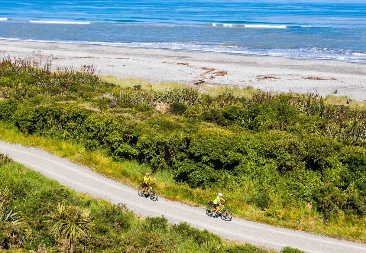 Cyclists riding along the coast line - West Coast of the south island.