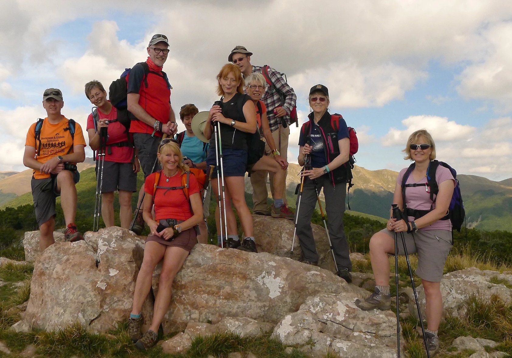 A group of hikers posing for a photo in the mountains of Tuscany.