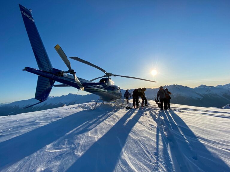 Backcountry skiers on top of a peak after being dropped by a helicopter, near Pemberton in British Columbia.