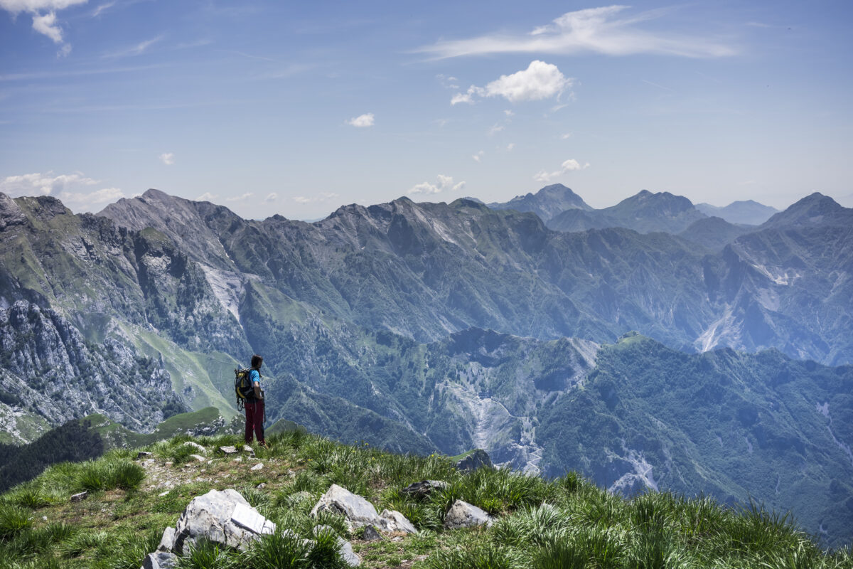 A hiker enjoying views while hiking in the mountains of Tuscany.