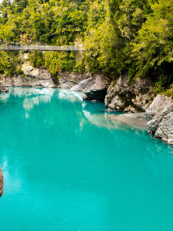 Cyclists on a path which is part of the iconic West Coast Wilderness Trail on the South Island in New Zealand