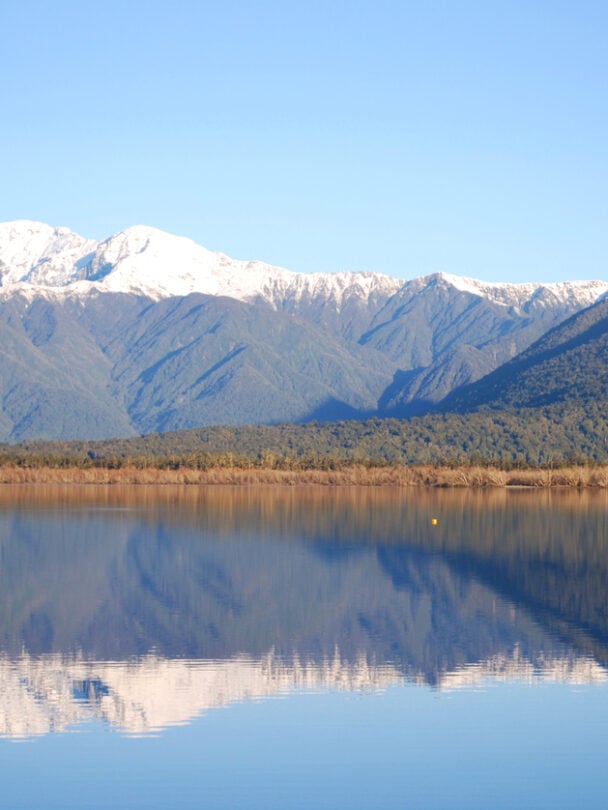 Cyclists on a path which is part of the iconic West Coast Wilderness Trail on the South Island in New Zealand