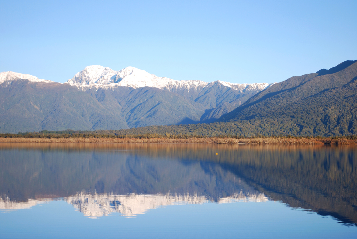 A lake in New Zealand with a backdrop of the Southern Alps.