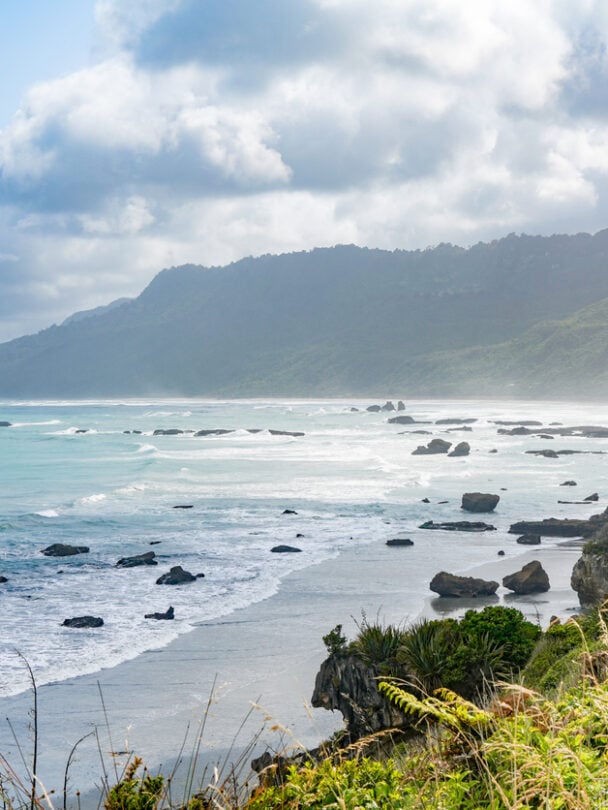Cyclists on a path which is part of the iconic West Coast Wilderness Trail on the South Island in New Zealand