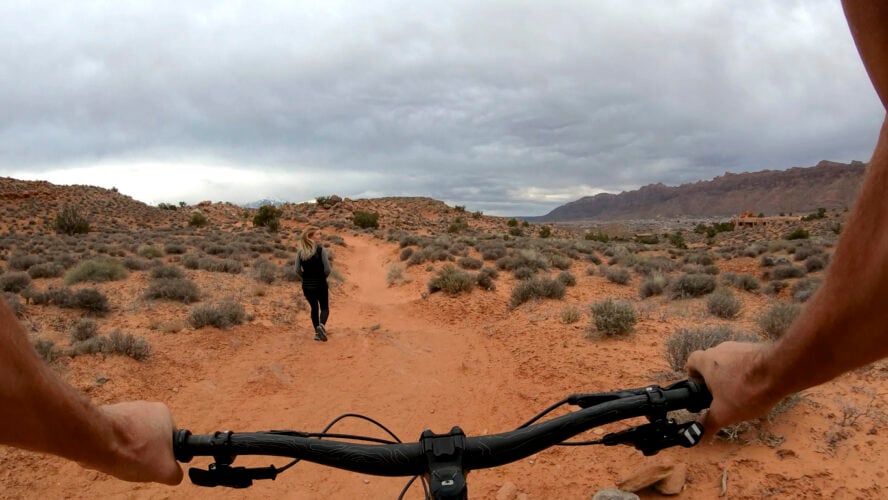 POV of a mountain biker passing hikers on a shared trail