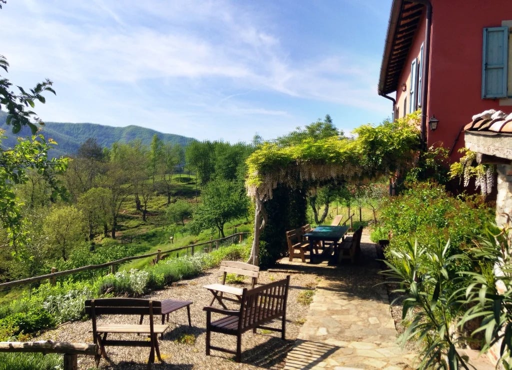 Terrace of a villa in Tuscany, overlooking a verdant valley. 