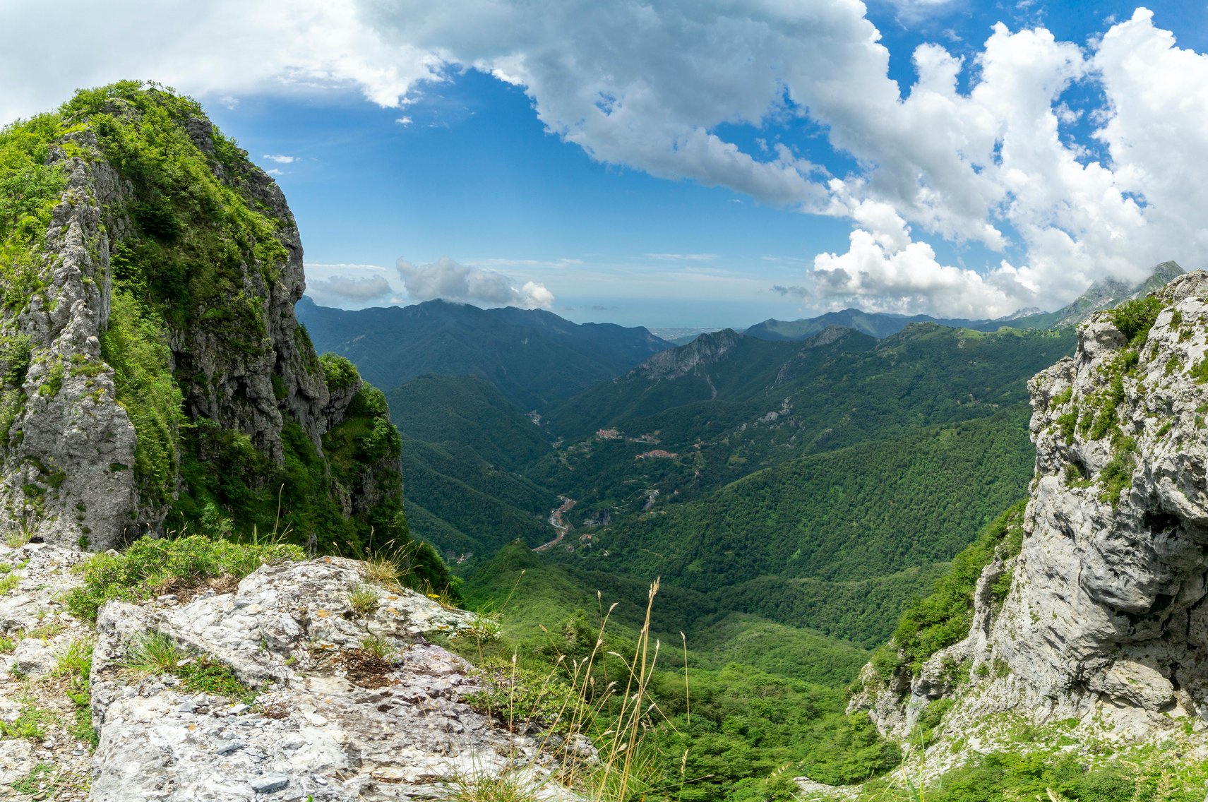 A verdant valley as seen by hikers in the mountains of Tuscany.