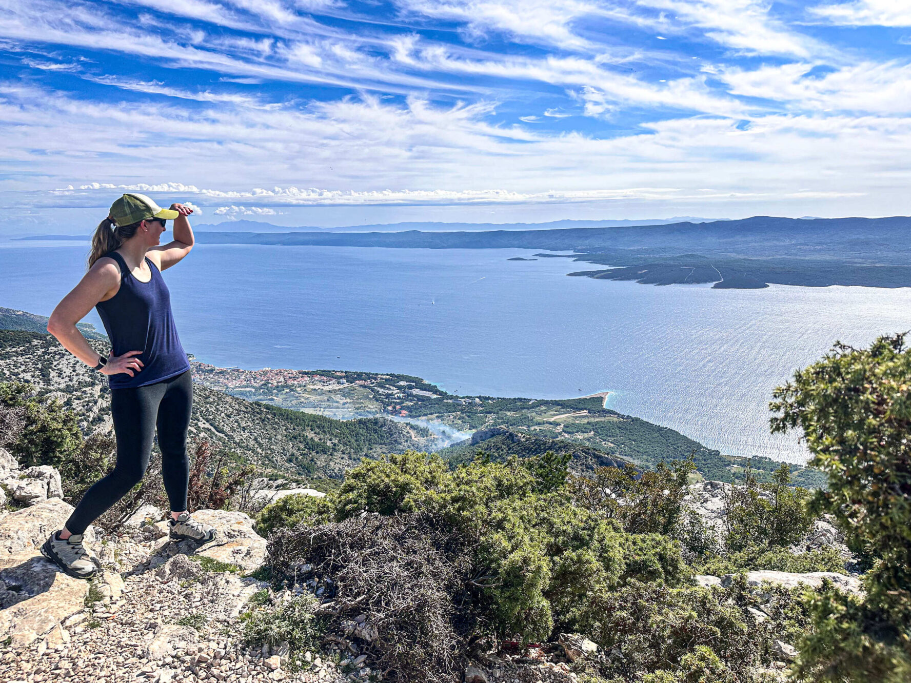 Hiker on Vidova Gora with a view of Zlatni rat beach on Brač island