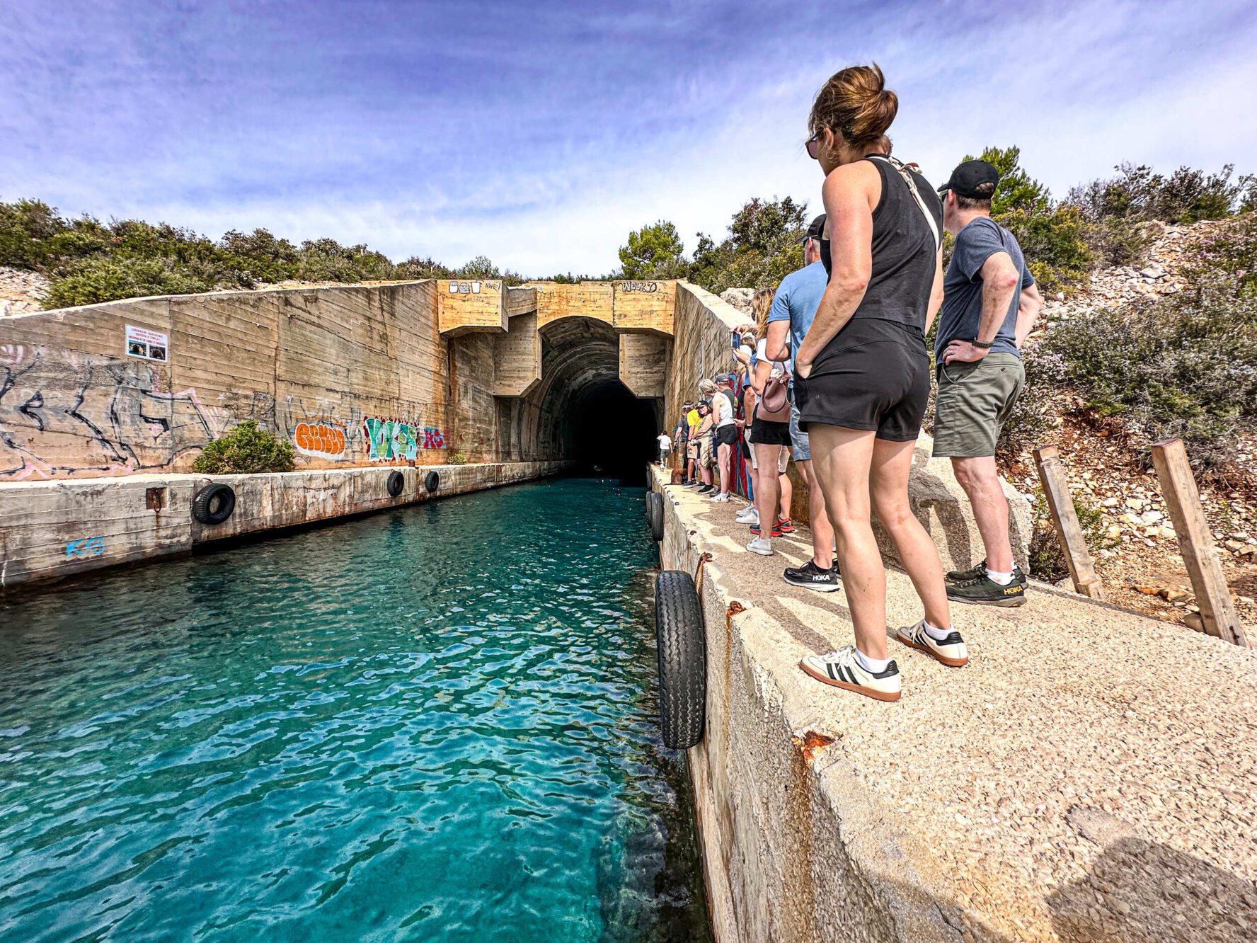 Hikers exploring a submarine tunnel on the island of Vis